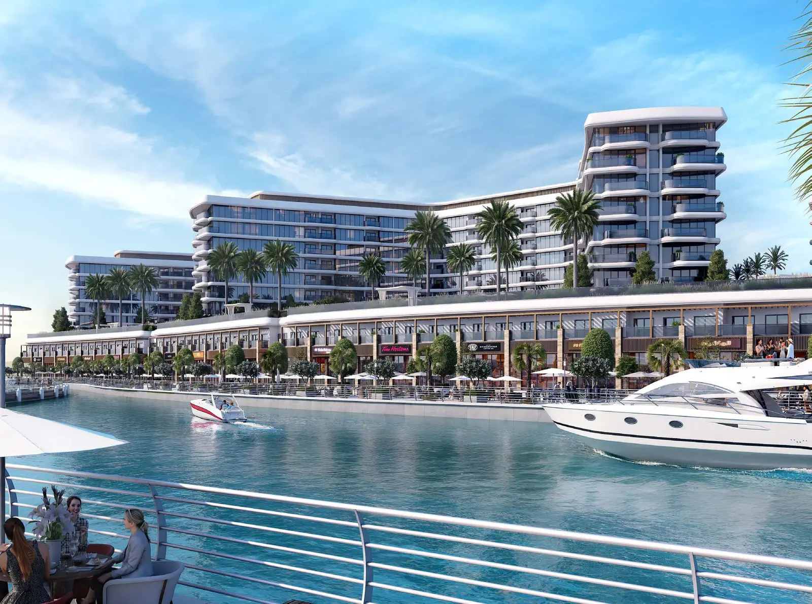 Yachtside Marina Residences at Sobha Siniya Island waterfront buildings along canal with bustling retail promenade and yachts