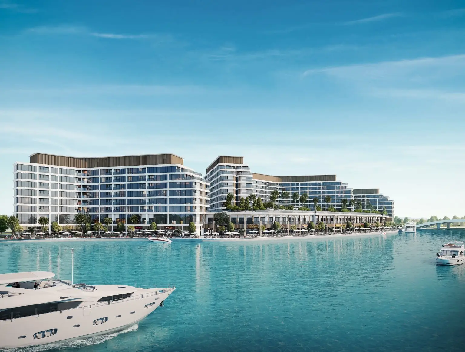 Panoramic view of Bayfront Marina Residences residential towers and waterfront promenade lined with luxury cruising yachts
