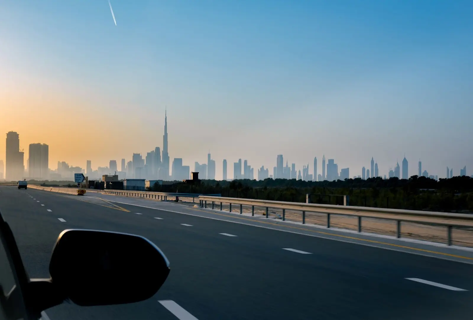 Highway driving route with Dubai skyline views showcasing effortless travel connectivity to Bayfront Marina Residences Umm Al Quwain.